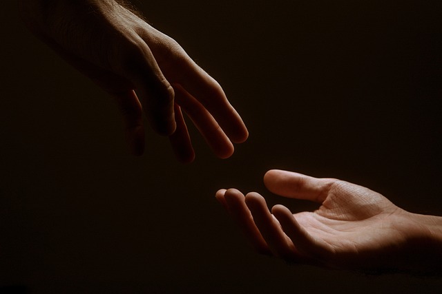 Two hands reaching for each other.